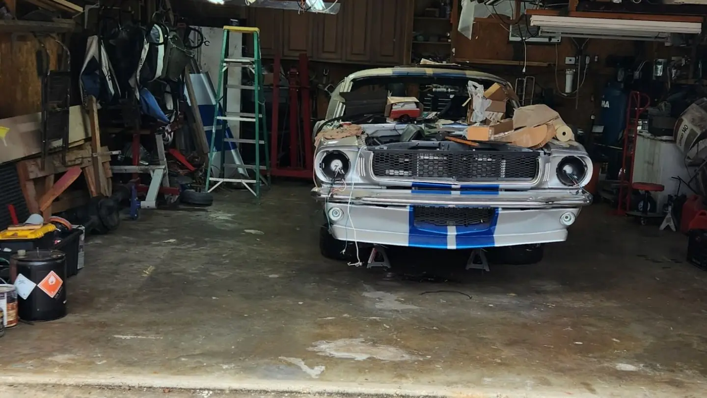After: the same garage with the floor cleared and swept around the car
